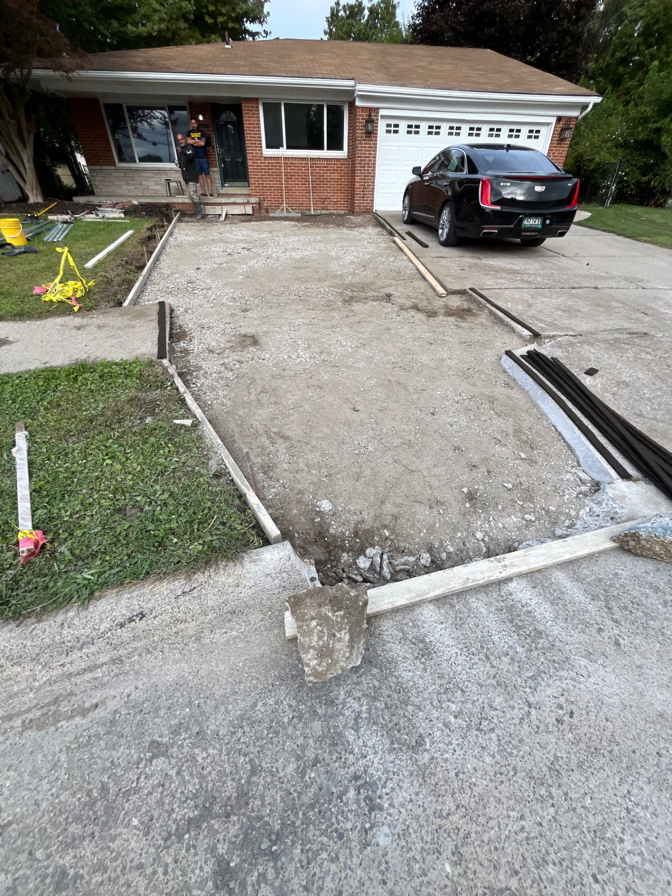 Driveway excavation and base preparation in front of a home